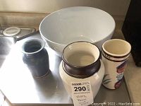 Photo showing three vases and a large white Pottery Barn popcorn bowl on a surface