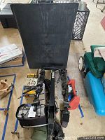 Overview photo showing black bike ramp, Thule bike rack with rubber straps, bike lift system and water bottles.