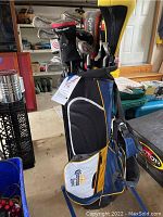 Golf bag standing upright filled with golf clubs, showing Corona Light logo on side pocket.