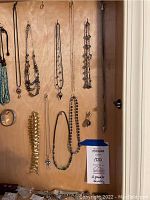 Jewelry displayed on wooden panel, front view