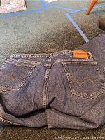 Back view of Wrangler fleece-lined jeans showing the leather label and pocket stitching.