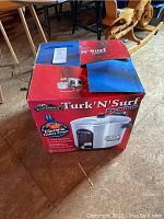 Original box of Turk'N'Surf Premium electric turkey fryer showing product image and brand details.