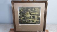 Front view of the framed block print artwork titled "Old Barns" by Carl Martin with detailed barn scene in earth tones.