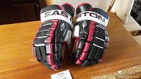 Pair of Easton SE 6 hockey gloves with visible front padding and wrist branding.