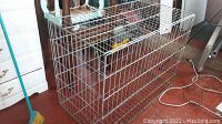 Full view of the metal dog cage showing the rectangular wire construction and front door.