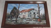 Full image of oil painting showing the stone mill building and tree landscape in wooden frame.