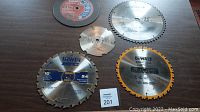 Overview of all five blades showing different tooth counts, brands, and blade types including DeWalt, Irwin, Diablo, a 12 inch blade, and an abrasive cutting wheel.