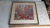 Full view of the framed vintage Tom Thomson art print on a table showing overall condition and size.