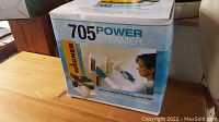 Photo showing front of the Wagner 705 Power Steamer box with image of the device and person using it to remove wallpaper.