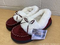 Pair of burgundy Rock Dove women's slippers with white faux fur lining and bows, new with tags, size large.