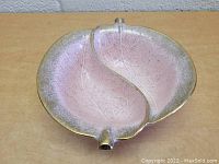 Top-down view of vintage pink divided bowl with leaf pattern and stem details.