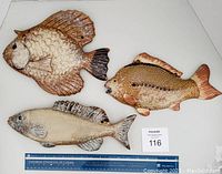 Top view of all three clay pottery fish with color and size shown, maxsold bidder number visible