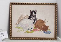 Front view of the framed crewel needlework showing four cats and bowls.