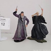 Dumbledore and Voldemort action figures side by side, showing poses, detailing, wands, and stands.