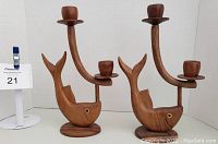 Full view of set of 2 wooden fish candle holders, empty, showing shape and size