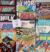Top view of multiple comic books including superheroes Hulk, Daredevil, Alpha Flight, The Walking Dead, Spider-Man, Superman, Wolverine