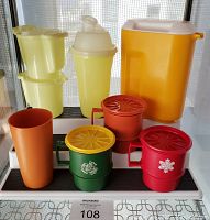 Photo showing full lot of various vintage Tupperware pieces including three lidded mugs, tumbler, large drink dispenser, smoothie shaker, four small yellow containers, and cream and sugar set