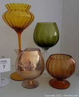 Four vintage art glass brandy snifter goblets in Empoli style, showing colors and shapes.