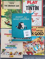Front covers of 8 vintage children's books featuring Tin Tin, Babar and Asterix characters; visible signs of wear.