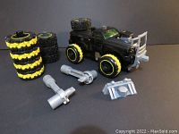 Tonka Mod Machine System truck DX-9 with rubber tires, grey plastic wrench accessories, and additional tires stacked alongside.