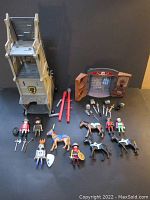 Overall lot showing siege tower, knights, horses, weapons, and castle wall piece
