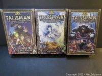 Three Talisman expansion game boxes: The Reaper, The Frostmarch, and The Blood Moon.