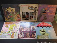 Lot of six Sesame Street and Muppet Show vinyl LP records arranged in two rows showing front album covers.