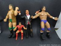 All four rubber wrestling figures displayed against black background.