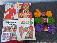 Photo showing all books and yarn skeins arranged flat for lot overview