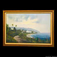 Front view of the original Mediterranean coastal waterscape oil painting on canvas, showing the full framed artwork with visible shoreline, buildings, palm trees and clouds.