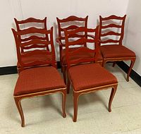 View of 5 French Country red painted dining chairs, 4 side chairs and 1 armchair, showing upholstery and overall condition.