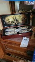 Founding Fathers cutlery set in open wooden box displaying cutlery and inside lid graphics