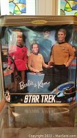 Full shot of Barbie and Ken dolls dressed in Star Trek uniforms in original gift box.