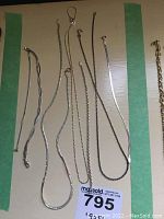 Photo of six sterling silver chains laid out, showing different chain styles and lengths