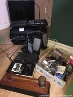 Full view of office electronics and supplies including keyboard, monitor, printer, mice, speakers, and wooden gavel with box of miscellaneous supplies.