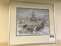 Framed 8x10 print showing four people ice skating in front of a large historic building with a tower, winter setting, signed by Shirley Hulley.