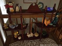 Photo showing full wooden shelf with multiple knick knacks arranged across its tiers
