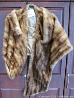 Front view of mink stole hanging on hanger showing full length and fur texture