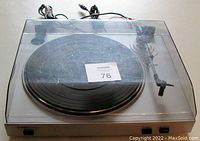 Top view of ION USB Turntable with clear dust cover showing dust cover scratches and seller's tag.