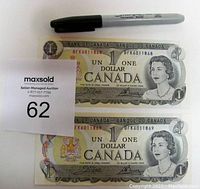 Two front views of sequential 1973 Canadian one dollar bills with serial numbers BFK6011868 and BFK6011869, showing Queen Elizabeth II portrait and denomination.