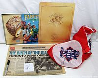 Lot overview photo showcasing all five Toronto Blue Jays collectibles arranged together including newspaper, programs, book and signed tote bag.