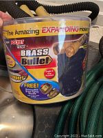 Close-up of the expandable Pocket Hose Brass Bullet packaging showing product details and accessories included.