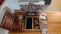 Overview of board games including Clue, chess pieces, backgammon set, decks of cards