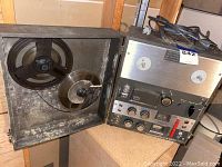 Front panel and overall view of the vintage Radio Shack reel to reel tape recorder, showing the control knobs and the power cord coiled on top.