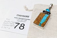 Image of pendant on linen drawstring bag with auction lot number tag