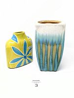 Front view of two pottery vases side by side, showing size and color contrast.