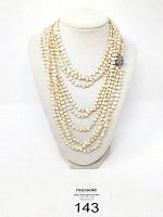 Full display of the long freshwater pearl necklace draped multiple times on a mannequin bust showing the overall length and multiple wraps.