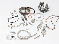 Group view of various jewelry pieces showing bracelets, earrings, rings and necklace with rhinestones, crystals and leather.