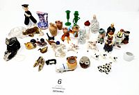 Photo showing the full collection of assorted vintage and antique miniature collectibles made of plastic, ceramic, and glass arranged on a white background, featuring animals, figures, vessels, and decorative items.