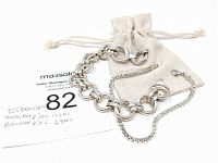 Two LG .925 sterling silver bracelets pictured with drawstring linen bag and handwritten measurement and weight note. Bracelets positioned to show link styles and clasps.
